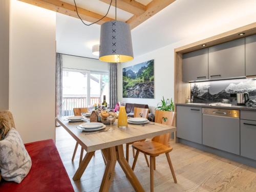 a kitchen and living room with a wooden table and a dining room at Apart33 Top 1-25 in Haus im Ennstal
