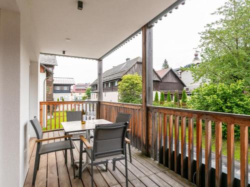 a patio with a table and chairs on a deck at Apart33 Top 1-25 in Haus im Ennstal