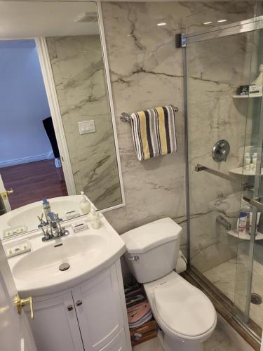 a bathroom with a toilet and a sink and a shower at Downtown Toronto House Central 2BED 2BATH Subway Free Parking in Toronto