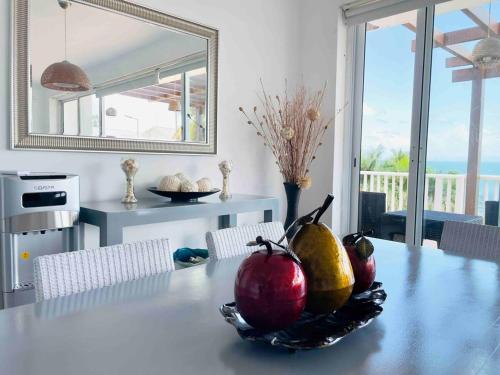 a dining room table with a bowl of fruit on it at Paradise Retreat Peace Relaxation in Santa Bárbara de Samaná