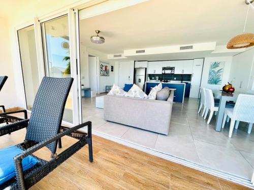 a living room with a couch and a table at Paradise Retreat Peace Relaxation in Santa Bárbara de Samaná