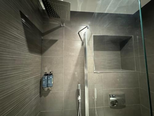 a shower with a glass door in a bathroom at Southgate Luxury Apartments-Jaquzzi Bath-Private Parking- 2 Min M62 in Elland