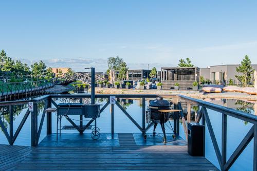 a walkway with a cart next to the water at SUN HOME in Palanga