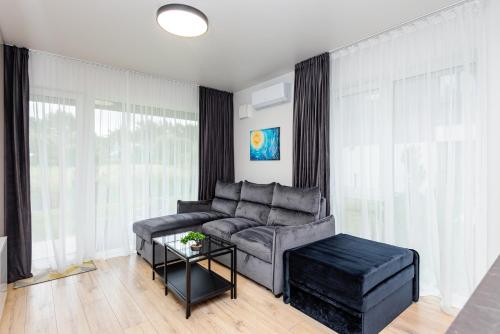a living room with a couch and a table at SUN HOME in Palanga