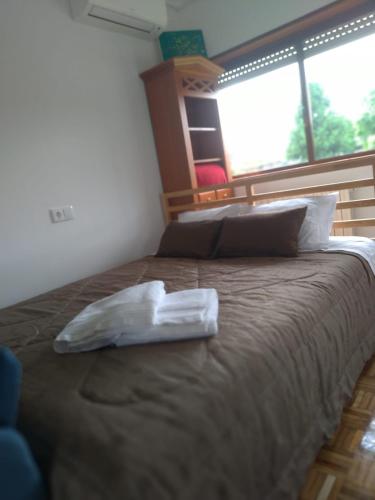 a large bed in a room with a pillow on it at CRALS - Casa do Corgo in Barroselas