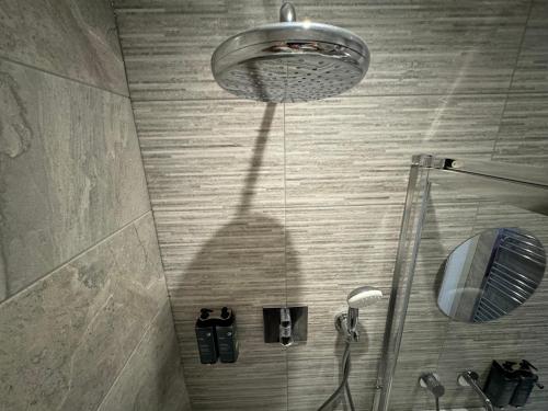 a shadow of a shower head in a bathroom at Southgate Luxury Apartments-Jaquzzi Bath-Private Parking- 2 Min M62 in Elland