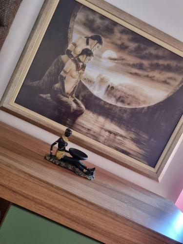 a picture of a woman on a shelf with a toy at Ana LUX in Dobrosin