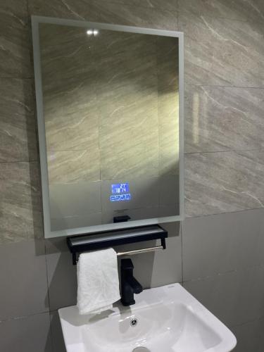 a bathroom sink with a large mirror above it at Tranquil Lakowe Getaway in Lagos