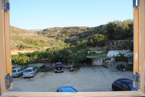 a view from a window of a parking lot at Bougainvillea Apartment in Petrás
