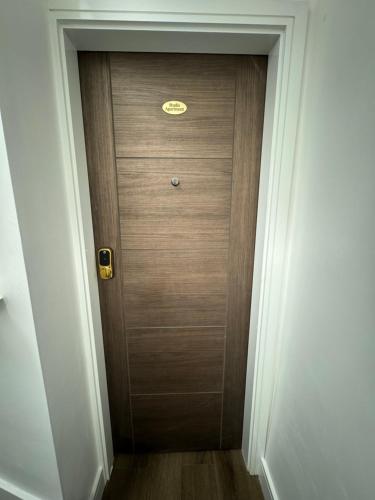 a wooden door with a sign on it in a hallway at Luxury 6-Bed House - 6 En Suite- Jaquzzi Baths - Private Parking - Sleeps 22- 2 Min M62 in Elland