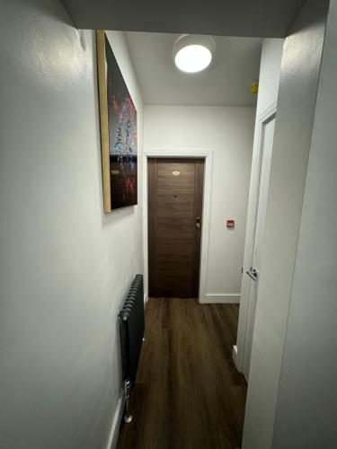 a hallway with a room with a door and a fan at Luxury 6-Bed House - 6 En Suite- Jaquzzi Baths - Private Parking - Sleeps 22- 2 Min M62 in Elland