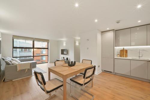a kitchen and living room with a table and chairs at Flat 315, 33 Birtton Street in London