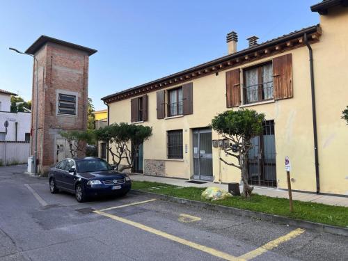 a car parked in a parking lot in front of a house at Terrazza su Volta Mantovana in Volta Mantovana