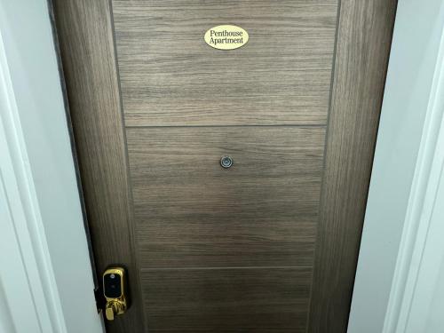 a wooden door with a sign on it at Luxury 6-Bed House - 6 En Suite- Jaquzzi Baths - Private Parking - Sleeps 22- 2 Min M62 in Elland