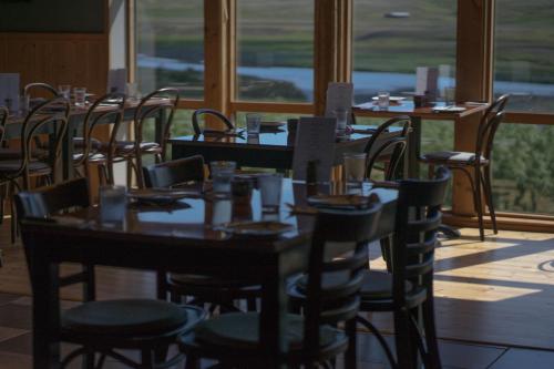a group of tables and chairs in a restaurant at Hótel Á in Reykholt