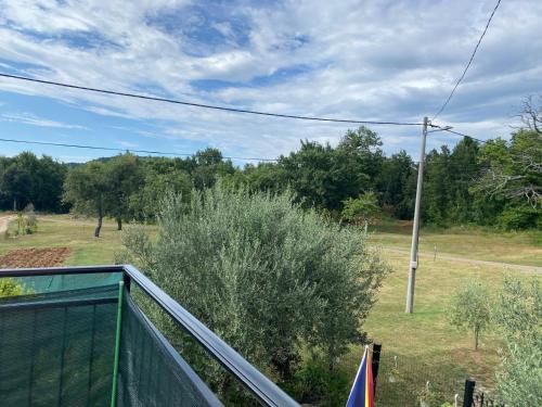 a balcony with a fence and a pole at App Damiani in Oprtalj