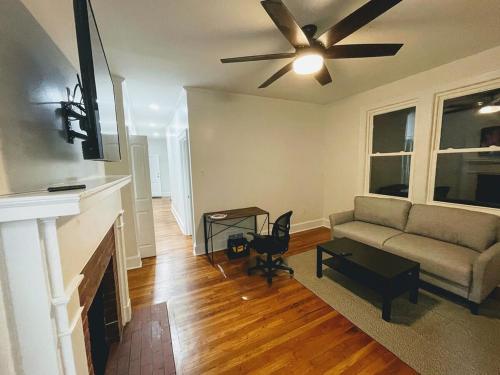 a living room with a couch and a ceiling fan at Renovated 1 bedroom in Forest Hills - B in Durham