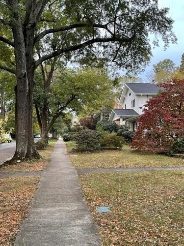 a sidewalk in front of a house with trees at Walk To Duke Campus! 3 Bedroom In Trinity Park! in Durham