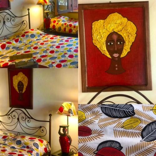a bedroom with a painting of a black woman at Maison Couleur Passion in Nianing