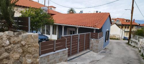 a house with a brown fence next to a street at Ma Maison Nafplio in Nafplio