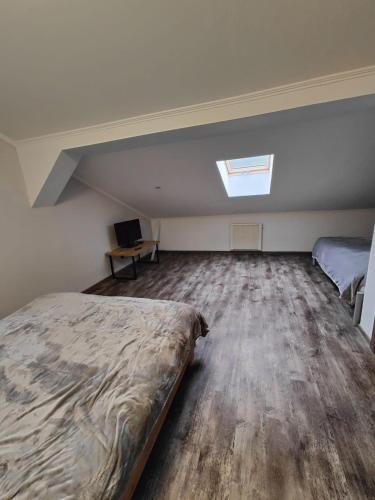 an attic bedroom with a bed and a window at Villa Pirken Hammer in Pirkenhammer