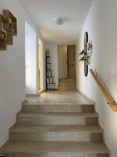 a staircase with a skateboard hanging on a wall at Ma Maison Nafplio in Nafplio
