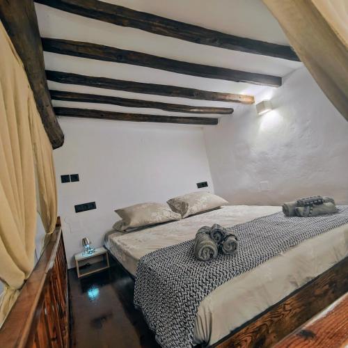 a bedroom with a bed in a attic at Frida' s Mansion in Dhragoulás