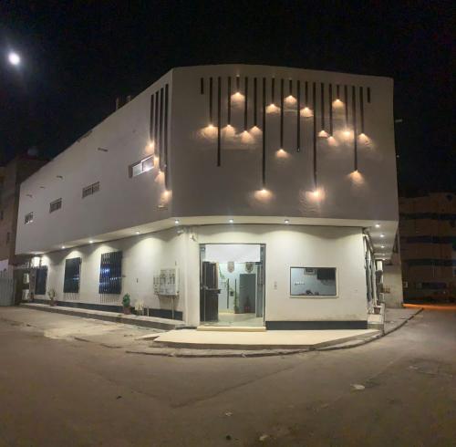 a white building with lights on top of it at Aya Hostel in Al Madinah