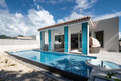 a swimming pool in front of a house at pool villa Sanrriott Okinawa Motobu in Motobu