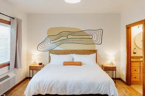 a bedroom with a bed with a surfboard on the wall at Mt Jackson Suite Close to Logan Health in Kalispell