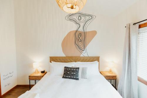 a bedroom with a white bed with a lamp above it at Mt Merritt Suite Logan Health Nearby in Kalispell