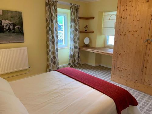 a bedroom with a large bed and a window at Apartment Yiorgos in Bovec