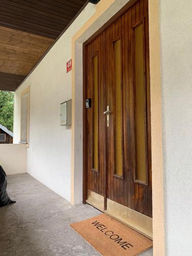 a door with a welcome mat in front of a house at Apartment Yiorgos in Bovec