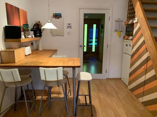 a kitchen with a counter and stools in a room at Apartment Yiorgos in Bovec