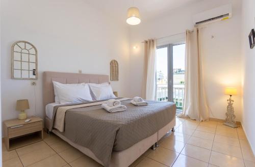 a bedroom with a bed with two towels on it at Spacious seaview apartment in Heraklion in Heraklio