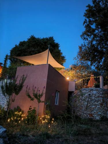 a building with a tent on top of it at night at Merlo House Dol Hvar in Stari Grad