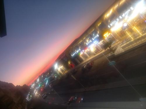 a group of buses with their lights on at night at شقة فندقية على البحر 3 in Hurghada