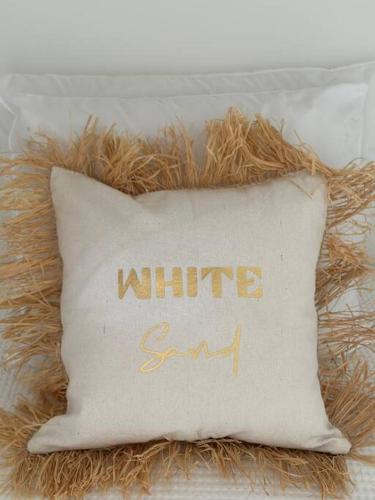 a white pillow with the words white grit at White Sand, Splendid 1 bedroom beachfront, Nettle Bay Beach Club in Baie Nettle