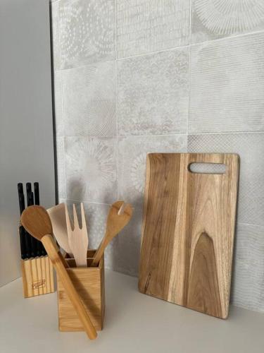 two wooden cutting boards and spatulas on a counter at White Sand, Splendid 1 bedroom beachfront, Nettle Bay Beach Club in Baie Nettle