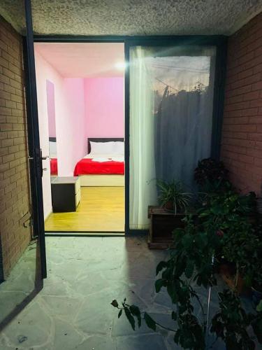 a view of a bedroom with a bed through a glass door at MM Hotel in Tbilisi City