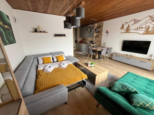 a living room with a couch and a table at Apartmán B3 Hrabušice in Hrabušice