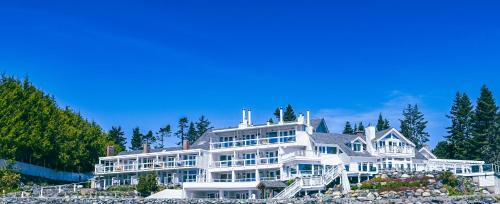 a large white house on top of a hill at Sooke Harbour House in Sooke