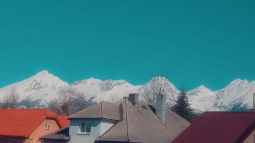 a view of snowy mountains from the roofs of houses at Apartmány Šafran Štrba in Štrba