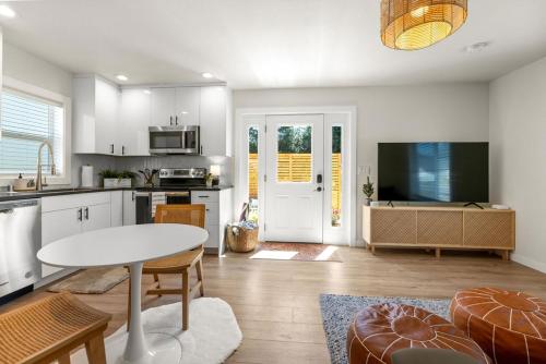 a kitchen with a table and a dining room at Modern Guest House Near Downtown! in Washougal