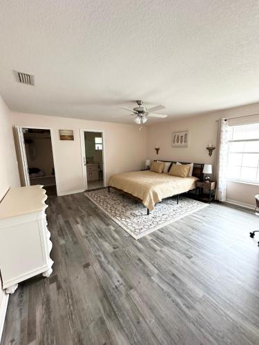 a bedroom with a bed and a ceiling fan at Tranquility Home near Beaches in Palm Coast