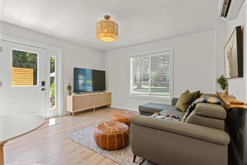 a living room with a couch and a table at Modern Guest House Near Downtown! in Washougal