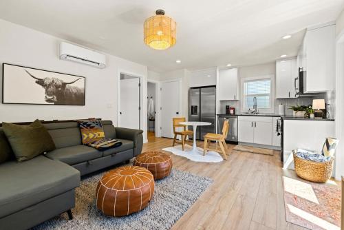 a living room with a couch and a kitchen at Modern Guest House Near Downtown! in Washougal