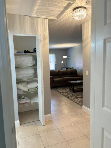 a living room with a couch and a closet at Coastal Breeze - 2BR Apartment in West Palm Beach