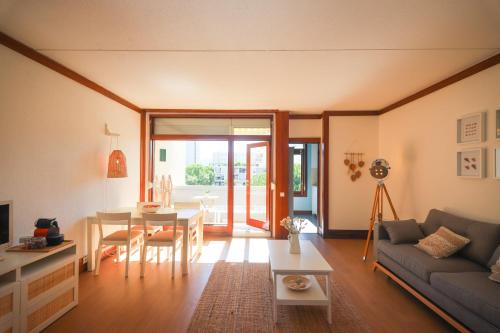 a living room with a couch and a table at Troia beach apartment by Dias de Sol in Troia