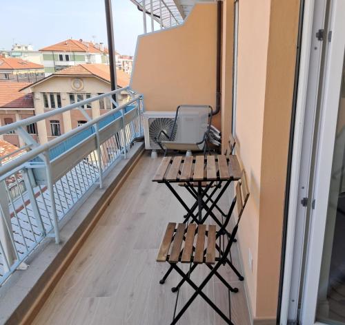 a balcony with a bench and a table at Attico Saluzzo centro 2 in Saluzzo